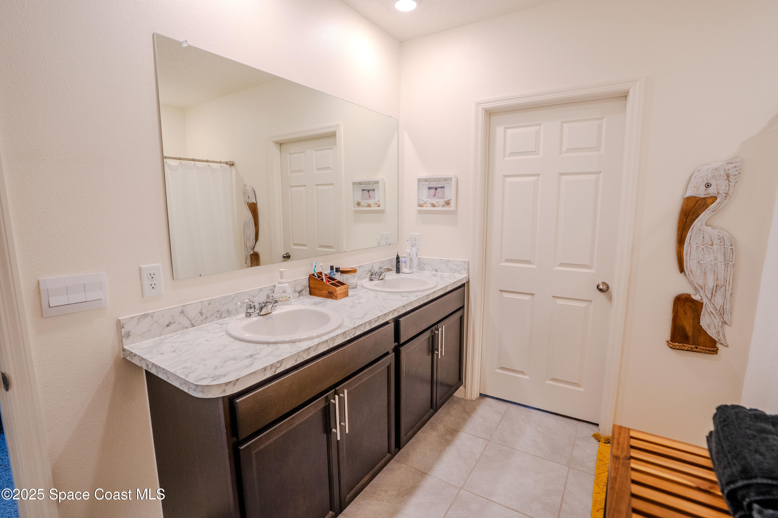 3409 Burrowing Owl Mims, FL 32754 - Photo 21 of 36 a bathroom with a sink and a mirror