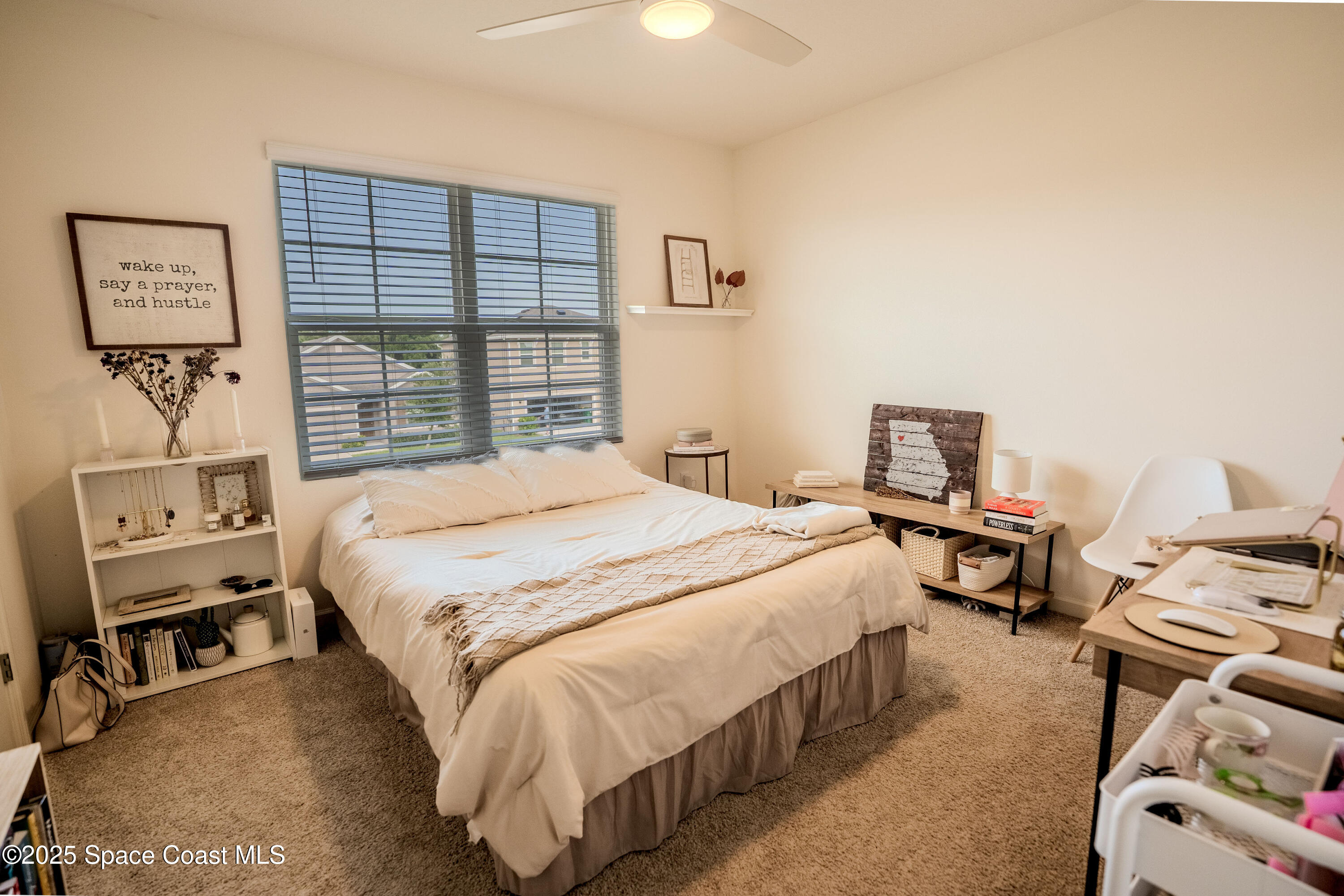 3409 Burrowing Owl Mims, FL 32754 - Photo 24 of 36 a bedroom with a bed and a tv on the dresser