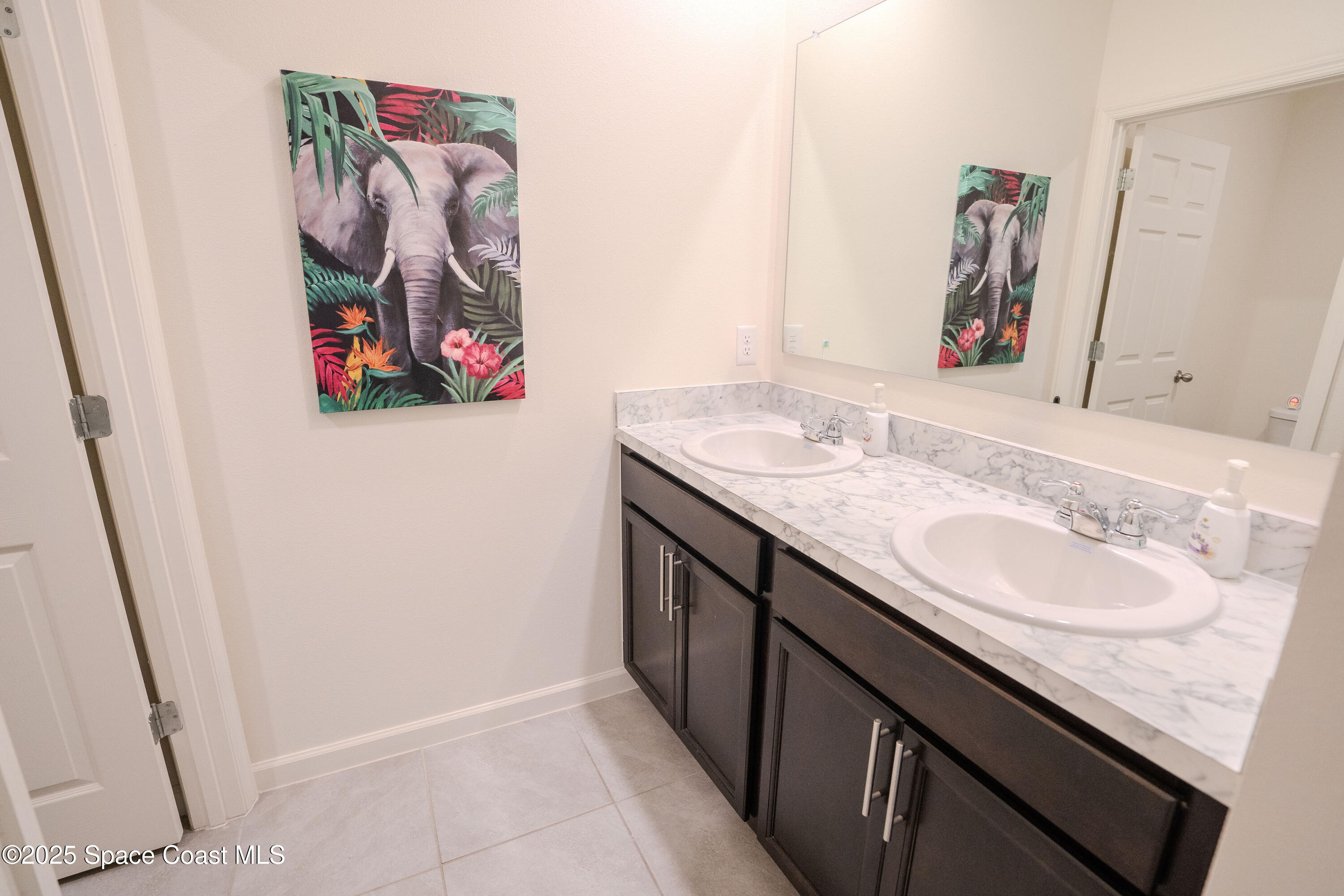 3409 Burrowing Owl Mims, FL 32754 - Photo 28 of 36 a bathroom with a granite countertop double vanity and a sink
