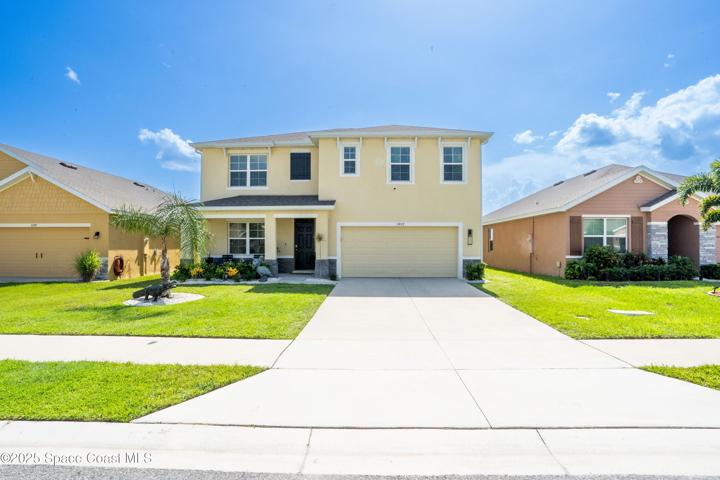3409 Burrowing Owl Mims, FL 32754 - Photo 3 of 36 a front view of a house with a yard and garage