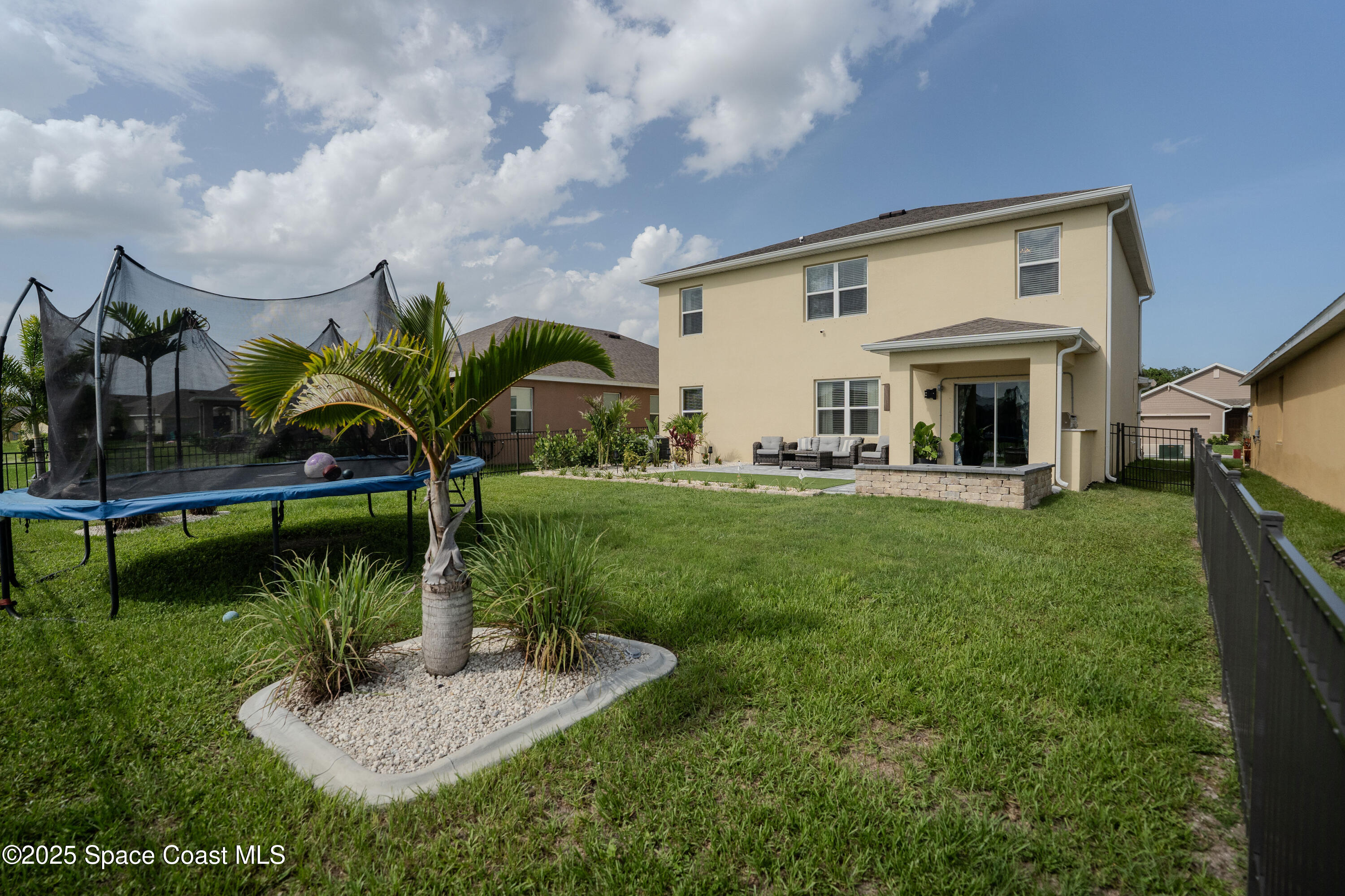 3409 Burrowing Owl Mims, FL 32754 - Photo 34 of 36 a view of a house with a backyard porch and sitting area