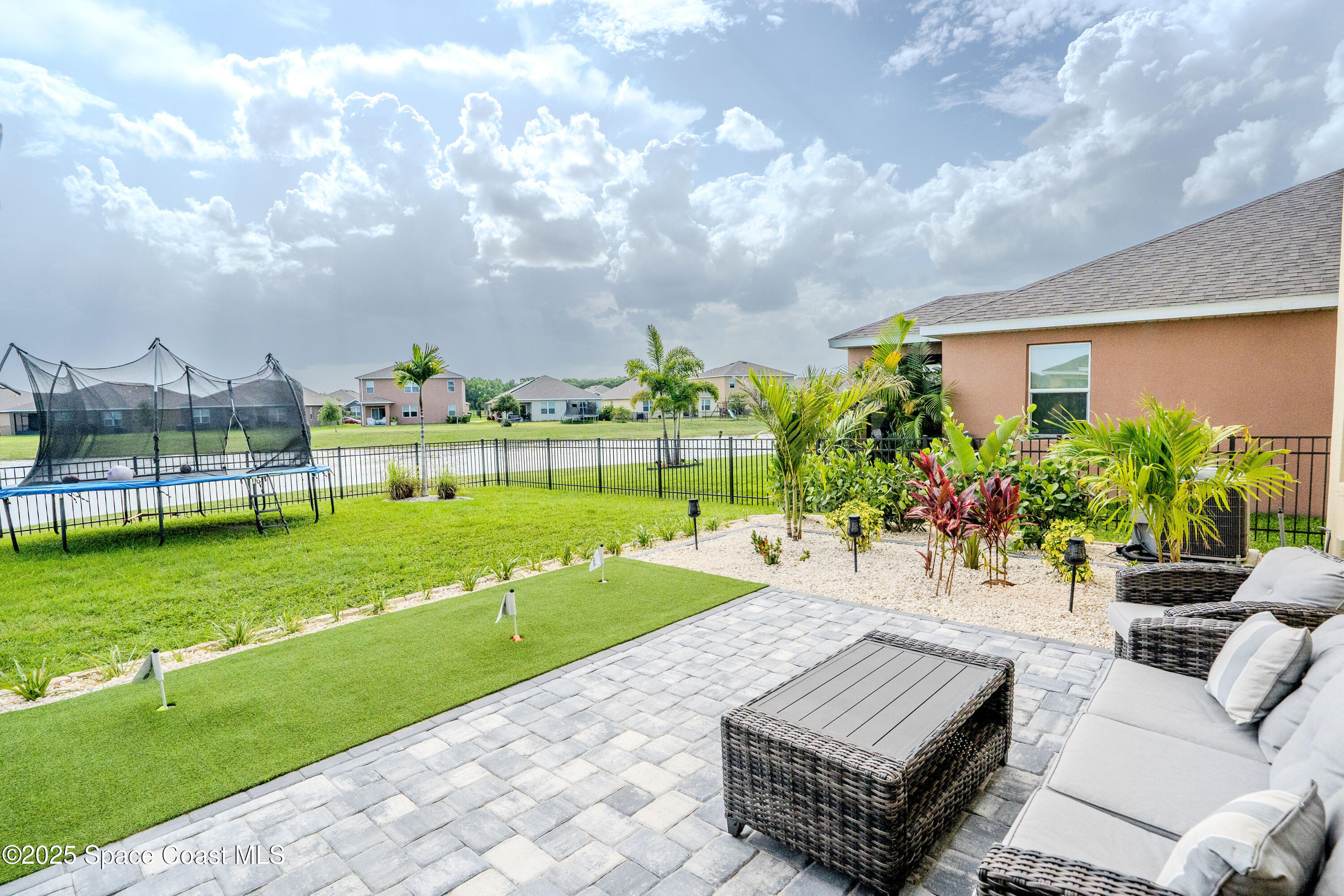 3409 Burrowing Owl Mims, FL 32754 - Photo 36 of 36 a view of a garden with a bench in front of the house