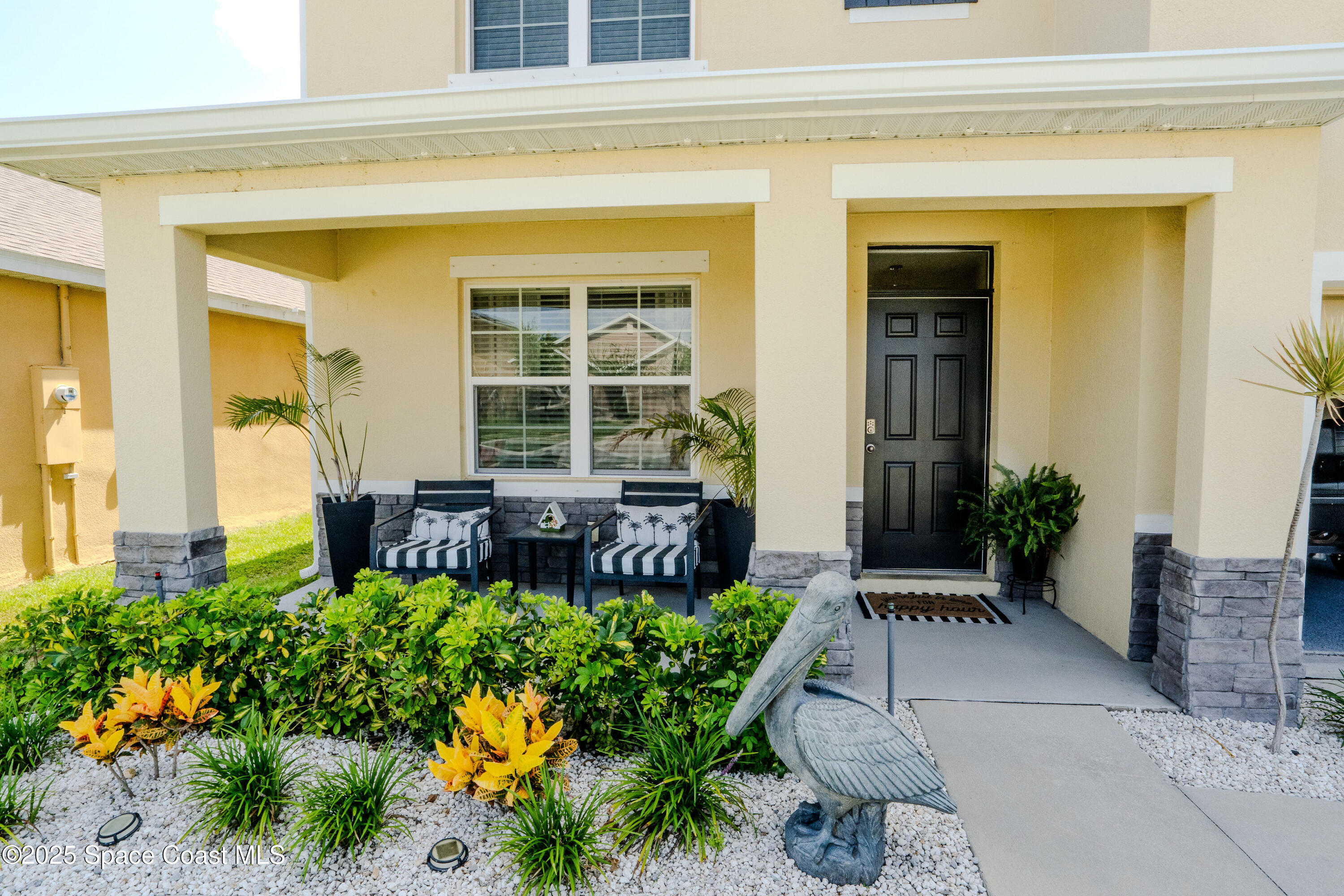 3409 Burrowing Owl Mims, FL 32754 - Photo 4 of 36 front view of a house with a chairs and potted plants