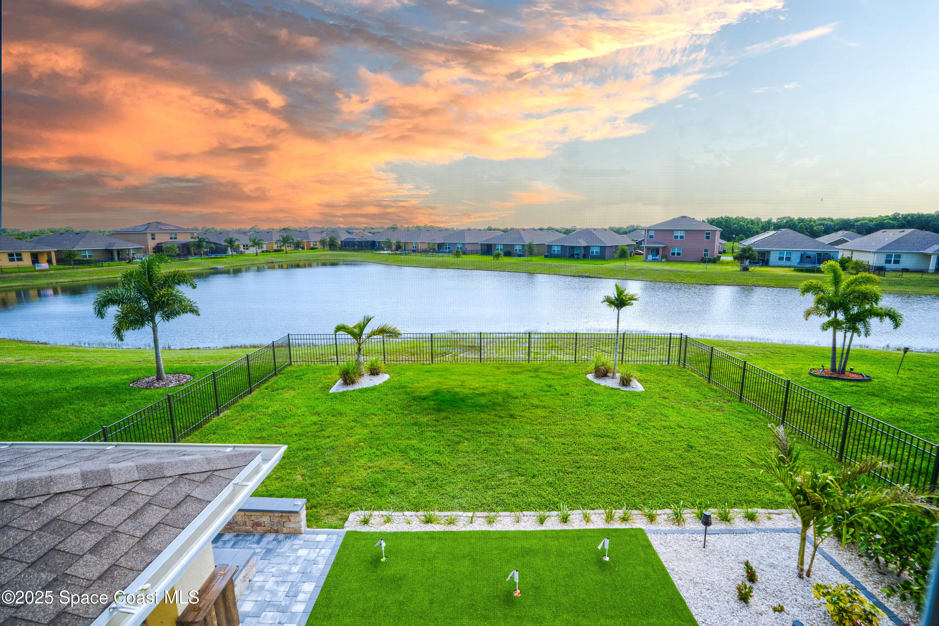 3409 Burrowing Owl Mims, FL 32754 - Photo 5 of 36 a view of a lake and a yard