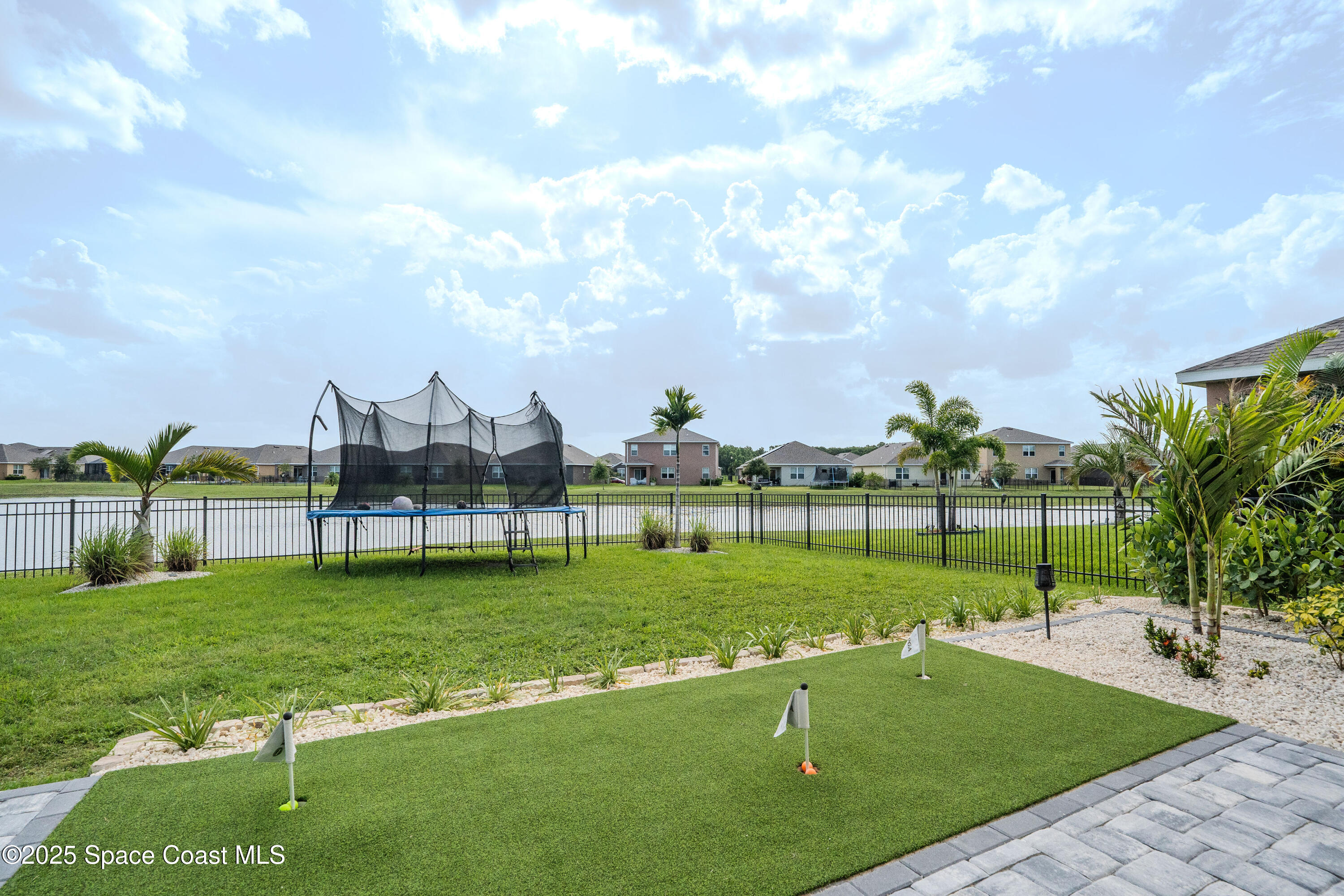 3409 Burrowing Owl Mims, FL 32754 - Photo 7 of 36 a view of a golf course with a garden