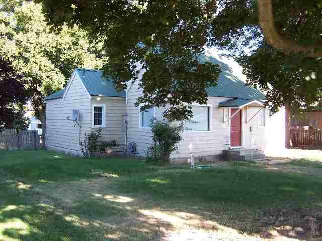 523 Cemetery Road Sunnyside, WA 98944 - Photo 2 of 2 a front view of a house with a yard and trees