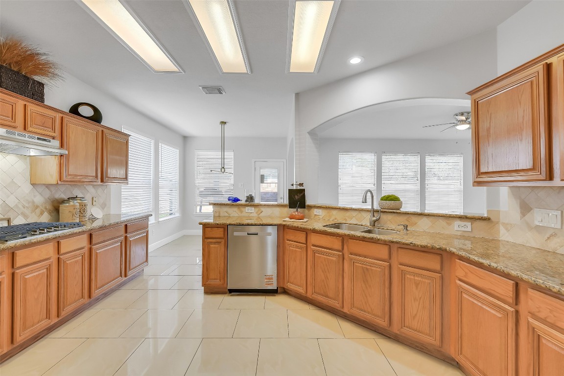12426 Shadowpoint Drive Houston, TX 77082 - Photo 11 of 42 a large kitchen with granite countertop lots of white cabinets