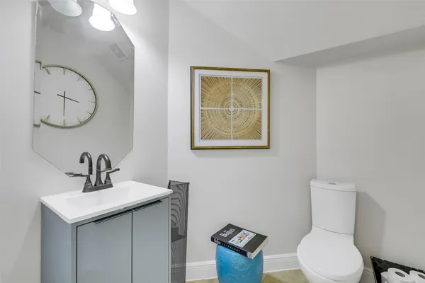 a bathroom with a toilet a sink and mirror