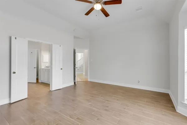a view of room with hardwood floor and ceiling fan