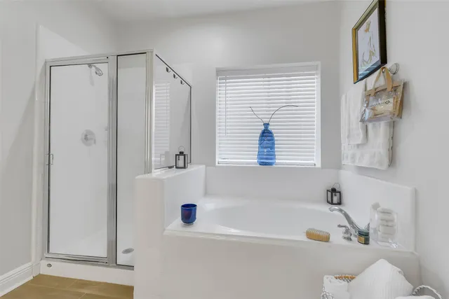 a bathroom with bathtub and a window