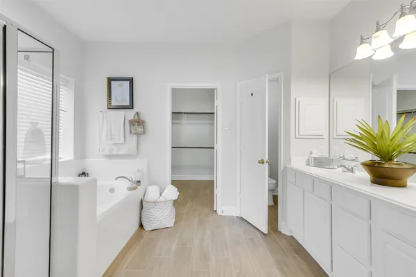 a bathroom with a tub sink and toilet