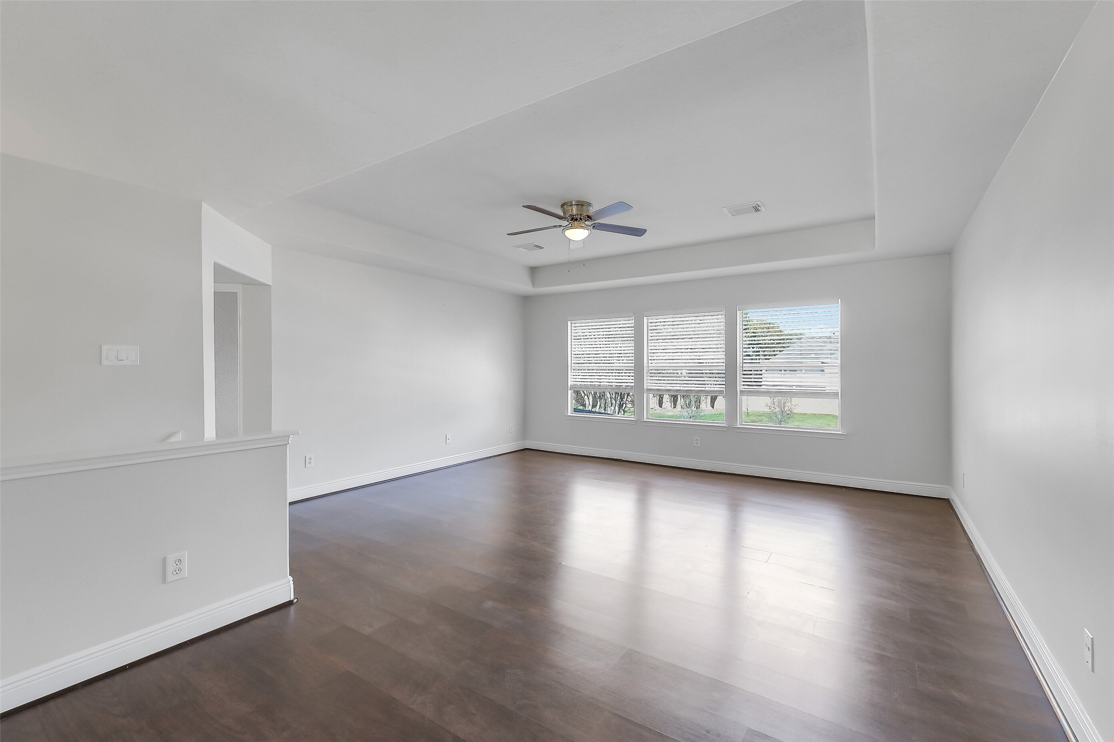 12426 Shadowpoint Drive Houston, TX 77082 - Photo 24 of 42 an empty room with wooden floor and windows