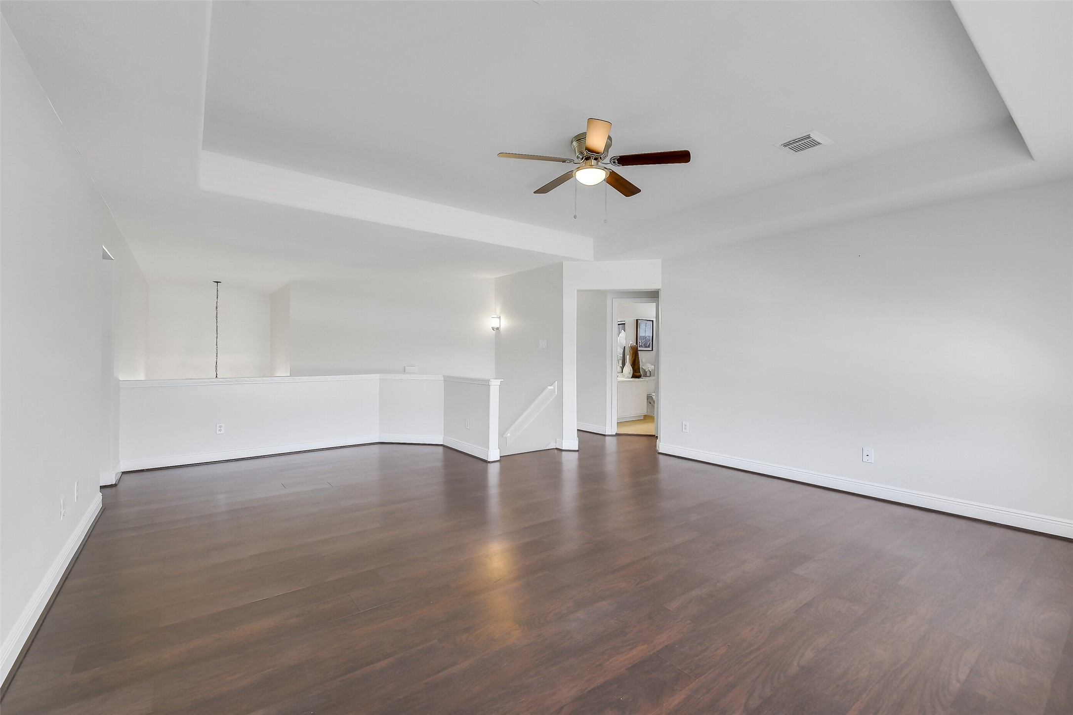 12426 Shadowpoint Drive Houston, TX 77082 - Photo 25 of 42 a view of empty room with wooden floor and ceiling fan