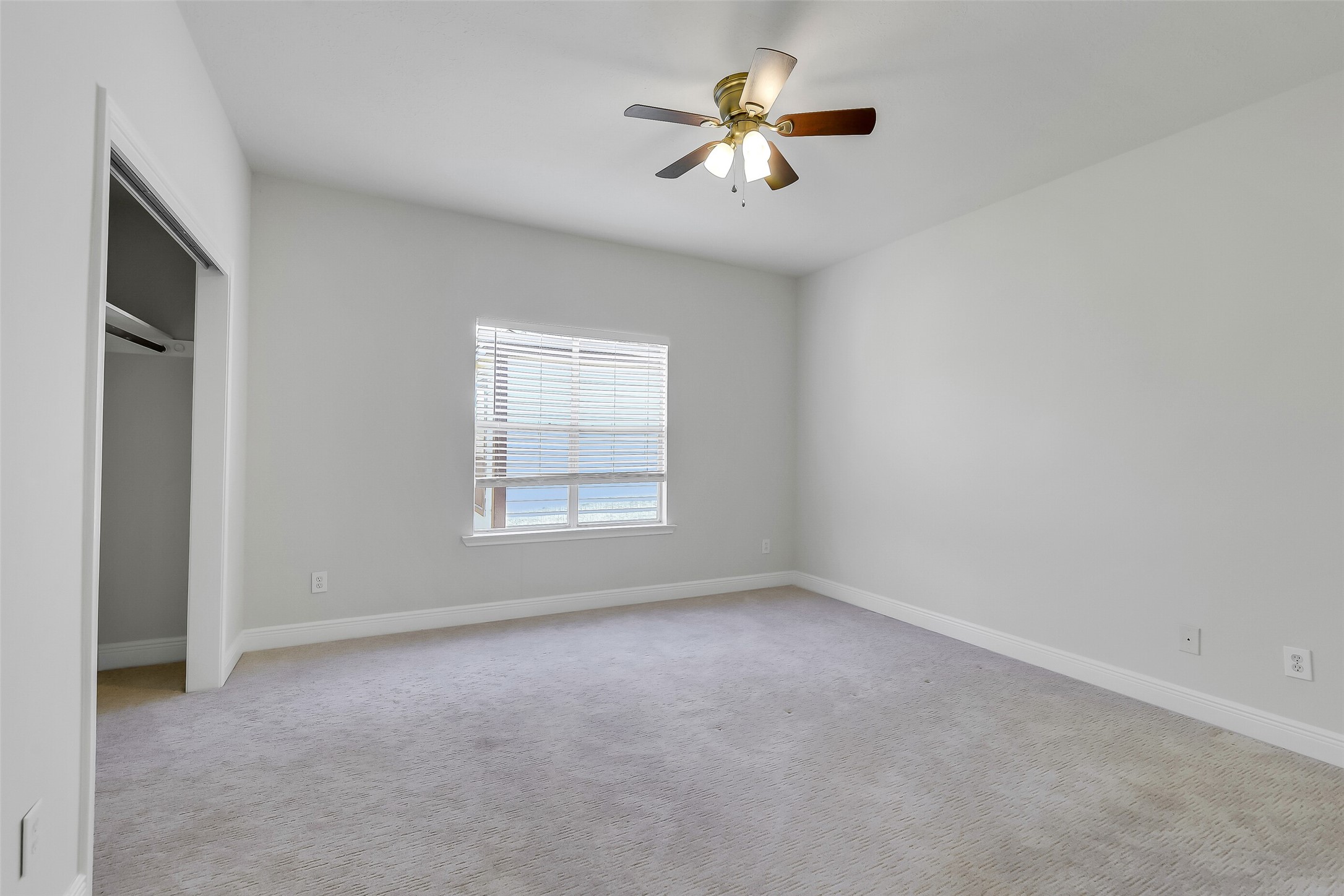 12426 Shadowpoint Drive Houston, TX 77082 - Photo 27 of 42 an empty room with windows and ceiling fan