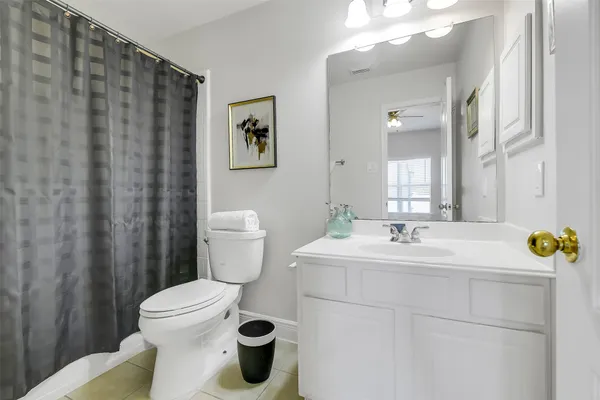 a bathroom with a sink toilet and mirror