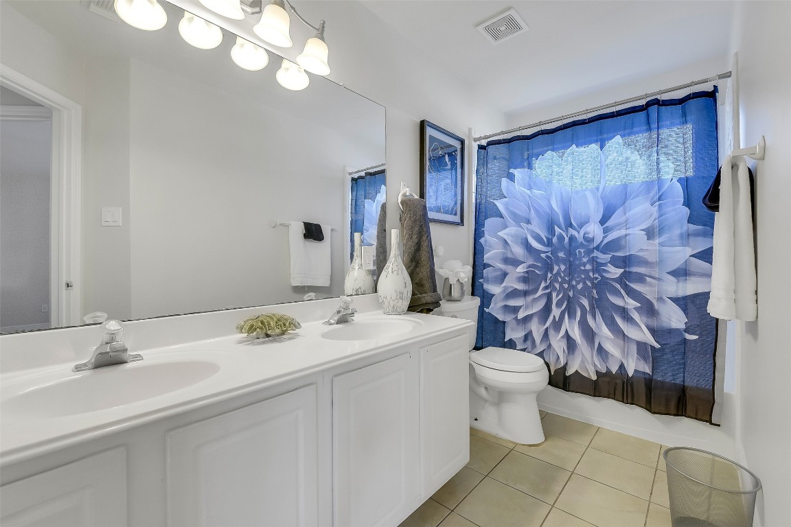 12426 Shadowpoint Drive Houston, TX 77082 - Photo 33 of 42 a bathroom with a sink a toilet and mirror