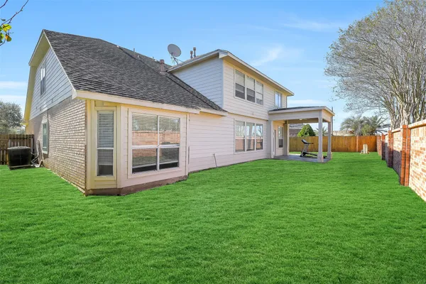 a view of a house with a backyard