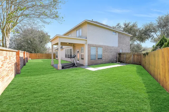 a view of a house with a yard and sitting area