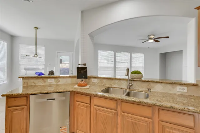a kitchen with sink cabinets and window