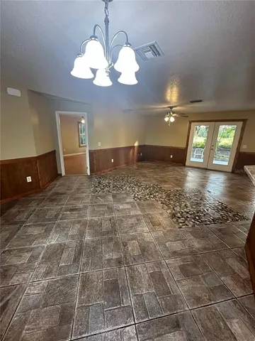 a view of a room with lots of furniture and chandelier