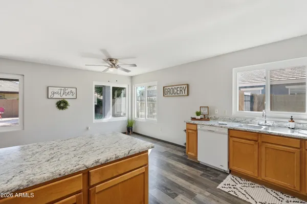 a bathroom with a granite countertop sink and a window