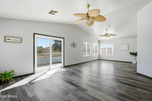 a view of empty room with wooden floor