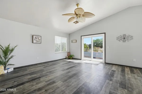 a view of empty room with wooden floor