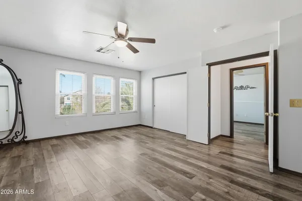 a bathroom with a granite countertop double vanity sink and a mirror