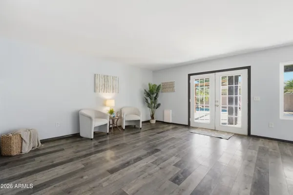 a living room with furniture and wooden floor