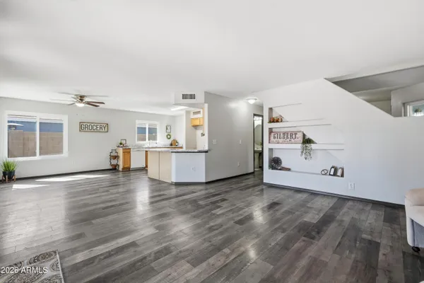 a view of a kitchen with wooden floor and a window