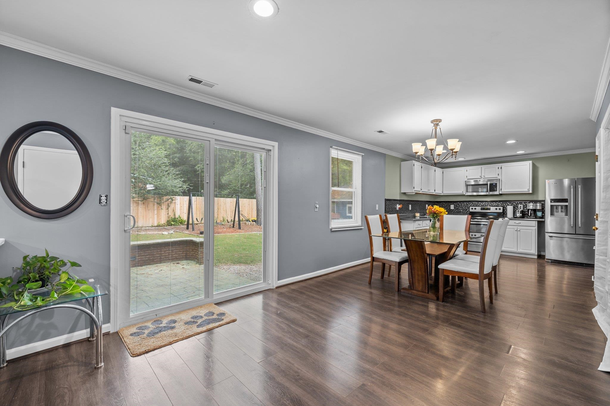 2208 Dobbin Place Raleigh, NC 27604 - Photo 15 of 42 a dining room with furniture a potted plant and a chandelier