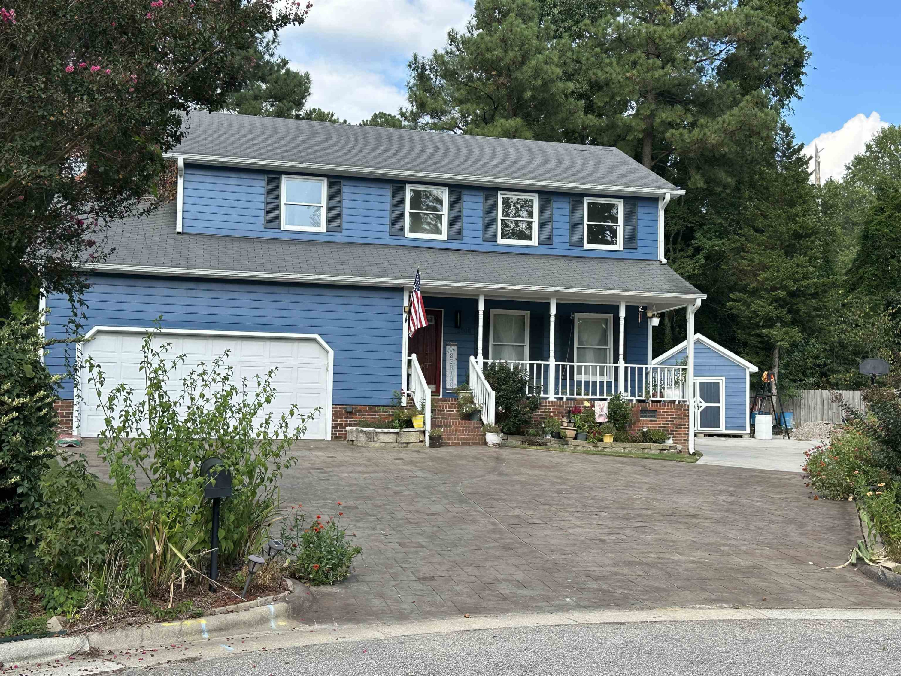 2208 Dobbin Place Raleigh, NC 27604 - Photo 2 of 42 a front view of a house with a garden and porch
