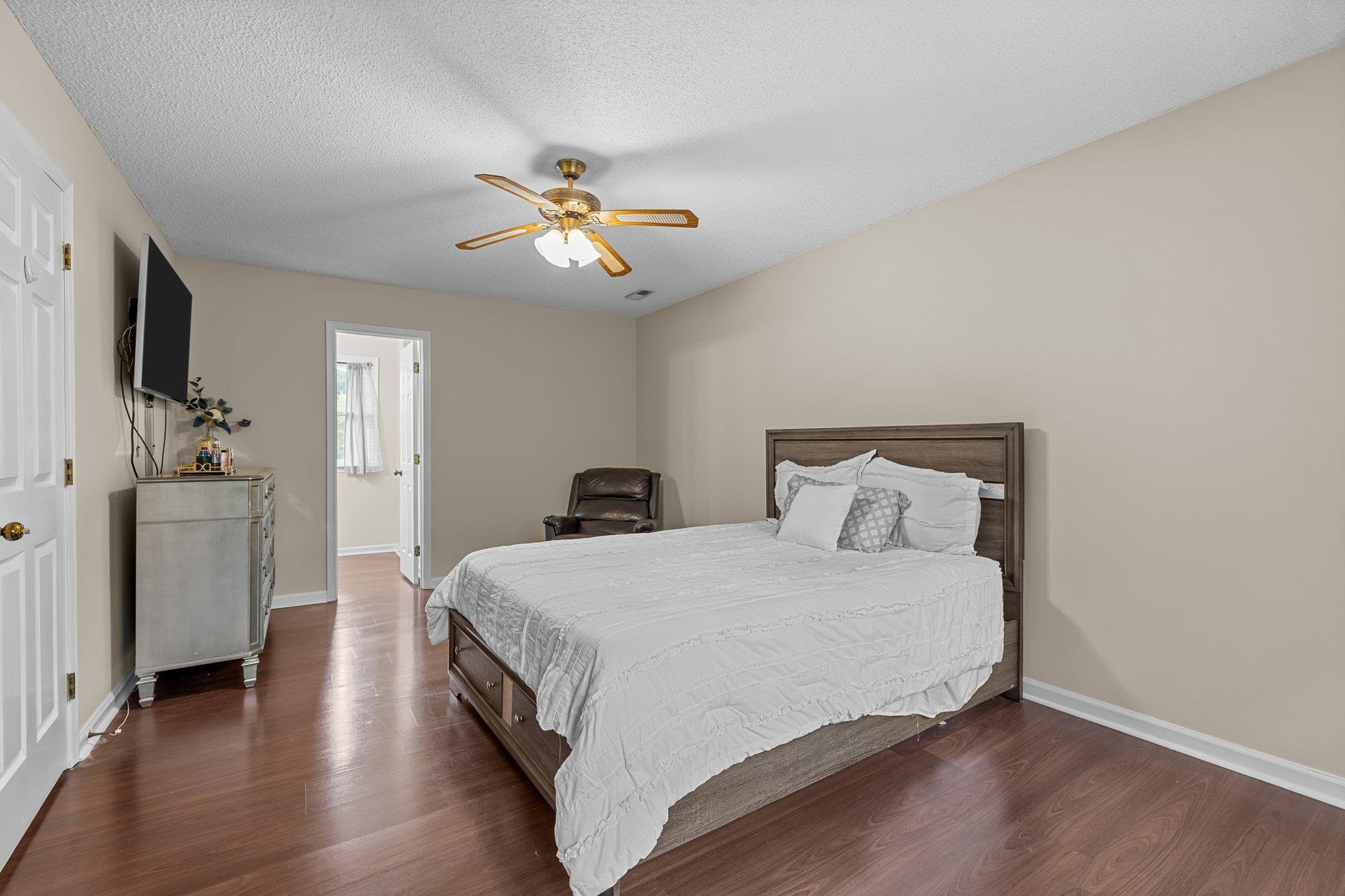 2208 Dobbin Place Raleigh, NC 27604 - Photo 23 of 42 a bedroom with a bed and a chandelier