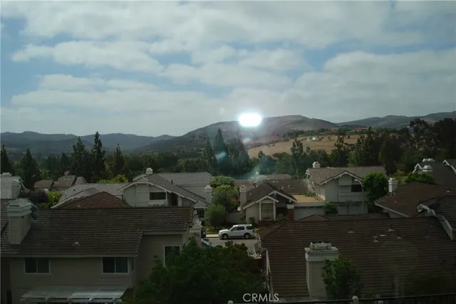an aerial view of a house with a garden and trees