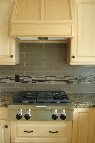 a stove top oven sitting inside of a kitchen