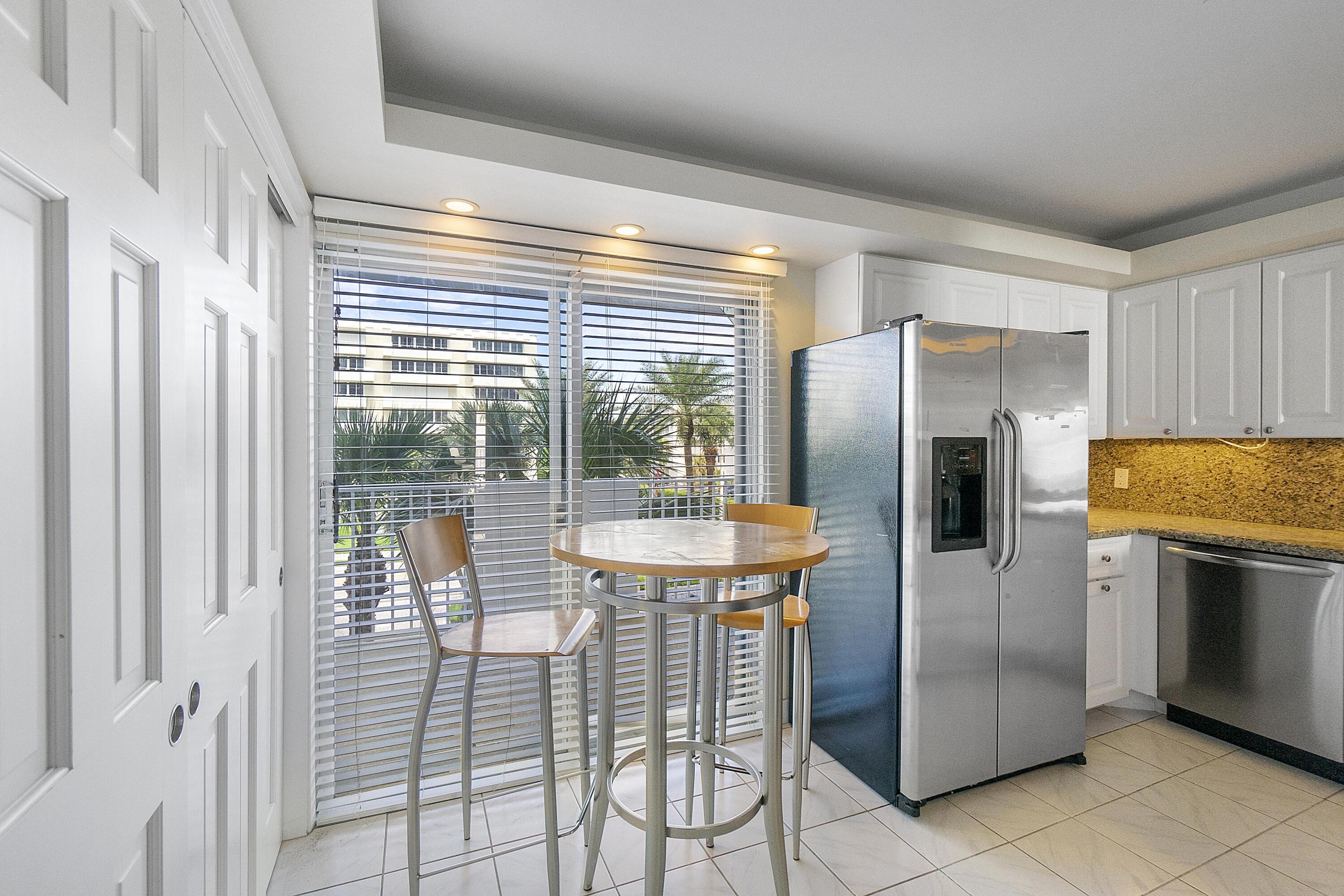 3000 South Ocean Boulevard, Unit 304 Boca Raton, FL 33432 - Photo 8 of 41 a kitchen with stainless steel appliances granite countertop a refrigerator and a stove top oven