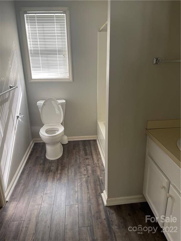 708 Patrick Road Gastonia, NC 28056 - Photo 11 of 15 a bathroom with a toilet and a window