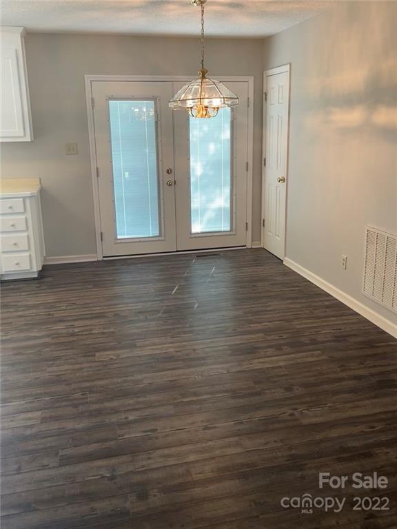 708 Patrick Road Gastonia, NC 28056 - Photo 7 of 15 a view of an empty room with window and wooden floor