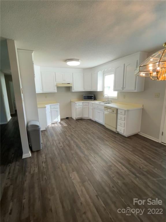 708 Patrick Road Gastonia, NC 28056 - Photo 8 of 15 a large kitchen with a lot of cabinets and wooden floor