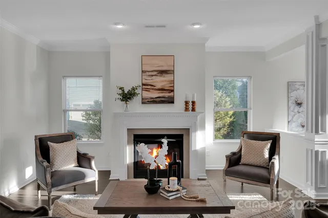 a living room with furniture a fireplace and a large window
