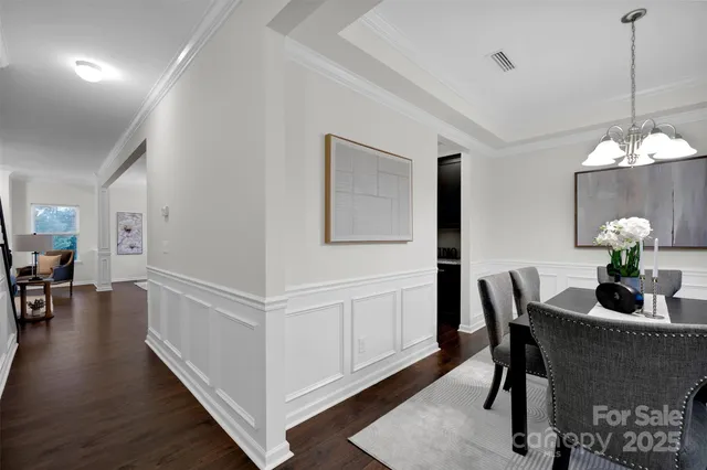 a dining room with furniture and wooden floor