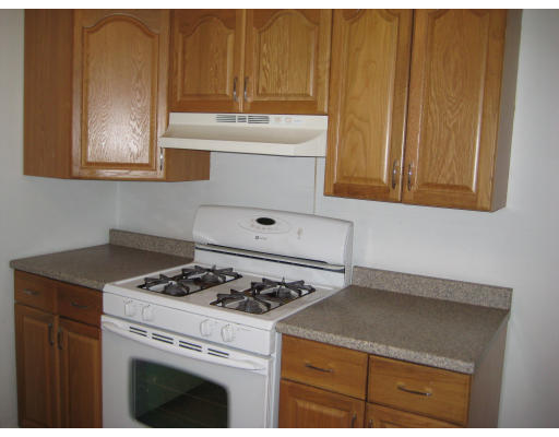 99 Russell Road Newton, MA 02465 - Photo 3 of 12 a white stove top oven sitting inside of a kitchen