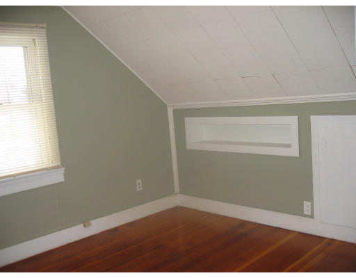 99 Russell Road Newton, MA 02465 - Photo 7 of 12 a view of an empty room with wooden floor and a window