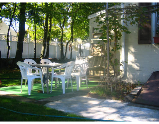 99 Russell Road Newton, MA 02465 - Photo 9 of 12 a view of backyard with table and chairs and potted plants