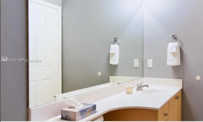 2280 Southwest 32nd Avenue, Unit 613 Miami, FL 33145 - Photo 11 of 15 a bathroom with a tub sink and mirror