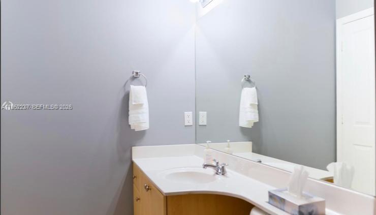 2280 Southwest 32nd Avenue, Unit 613 Miami, FL 33145 - Photo 12 of 15 a bathroom with a sink and a mirror