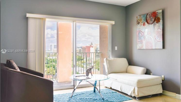 2280 Southwest 32nd Avenue, Unit 613 Miami, FL 33145 - Photo 2 of 15 a living room with furniture and a large window