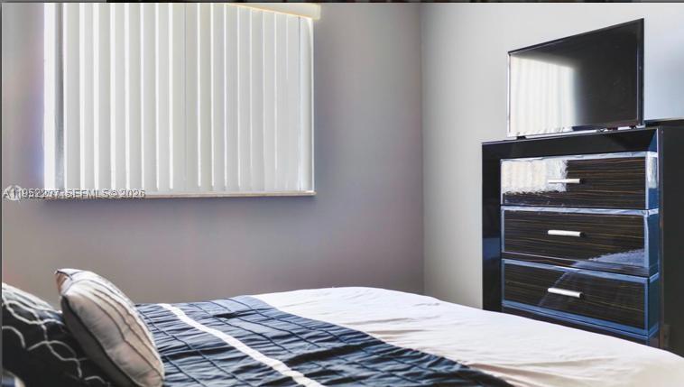 2280 Southwest 32nd Avenue, Unit 613 Miami, FL 33145 - Photo 6 of 15 a bedroom with a bed and a dresser