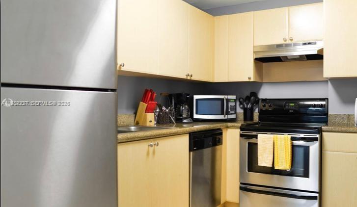 2280 Southwest 32nd Avenue, Unit 613 Miami, FL 33145 - Photo 10 of 15 a kitchen with stainless steel appliances a stove and refrigerator