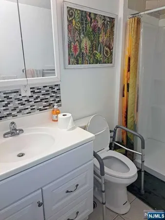a bathroom with a sink a toilet and a mirror